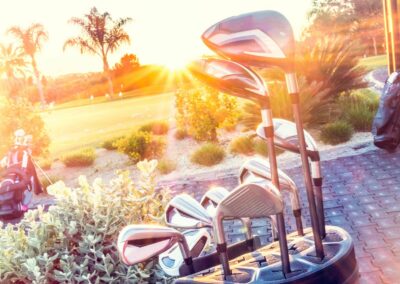 set of golf clubs gleaming in the morning sun.